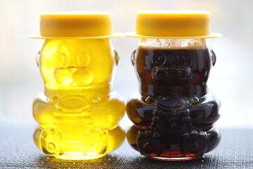A jar of a bear filled with honey.