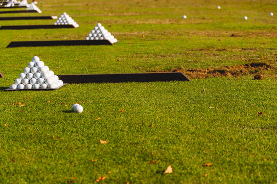 Pyramids of golf balls on a driving range