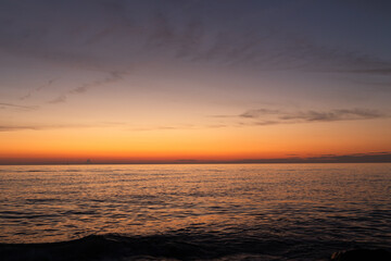 Sunset over the sea. The colors of a sea sunset. The composition of the seascape. Natural background