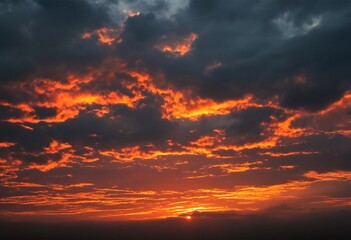 Fototapeta premium A dramatic orange and dark clouded sunset.