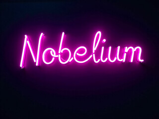neon A neon sign that says "nobelium" in pink letters. The sign is glowing