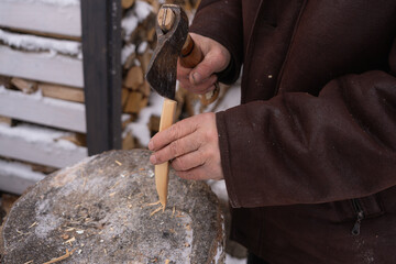Skilled craftsman shaping wood in winter workshop