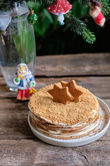 christmas honeycake on a wooden table. pine branches, stars christmas gingerbread cookies. New Year. Rustic. horizontal