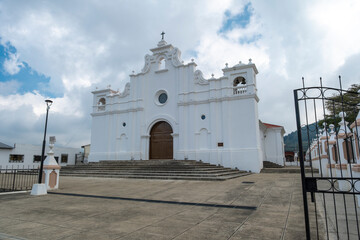 Front view and main entrance to the main Christian catholic church at the central park of a small...