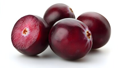 Obraz premium Four Fresh Purple Plums Displayed Together on a Reflective Surface with Bright Lighting