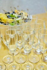 Lots of champagne glasses on the table. Festive reception