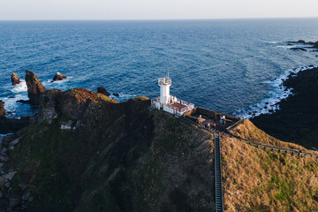 Jeju-do, Seopjikoji cape landscape with lighthouse and sea, east coast of Jeju Island, South Korea,...