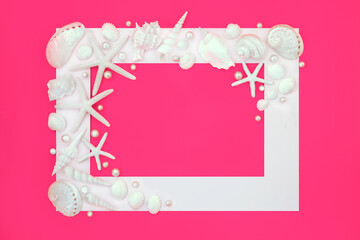 Pearls and white sea shell background with a variety of shells and frame border on vivid pink....