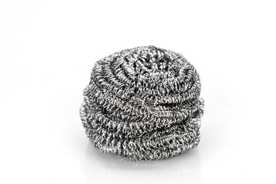 Stainless steel fiber in a ball shape is used for a pot scrubber on a white background.