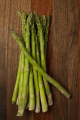 Raw asparagus bundle, on a cutting board.