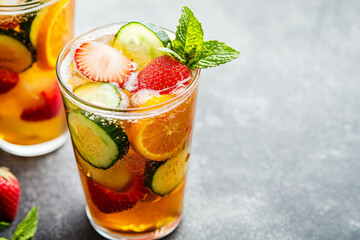 Traditional Pimms cocktail with lemonade, strawberries, cucumber, orange and mint 
