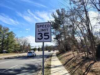 Washington, DC, USA - 03. 03. 2025: 35 mph speed limit sign on a rural unoccupied road, attention and information signs for drivers on roads in the USA
