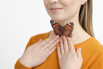 Enlarged butterfly-shaped thyroid gland on woman neck, isolated on white background. Treatment of...