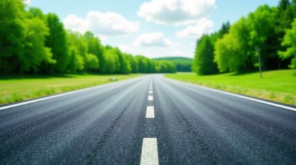 Fototapeta premium Asphalt Road Leading Through Lush Green Foliage on a Sunny Day, Beckoning the Traveler Towards a Serene Destination