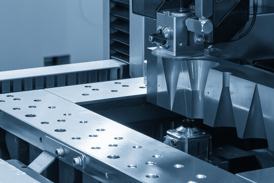 The die insert cutting process by wire EDM machine control by CNC program in the light blue scene.