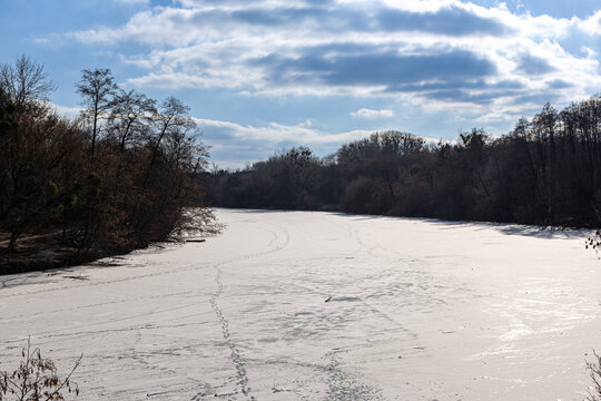 Frozen river in the forest. Winter landscape with river