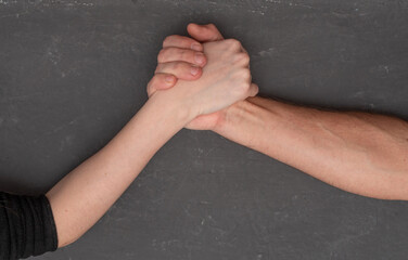 A man and a woman are engaged in arm wrestling. the struggle of the sexes