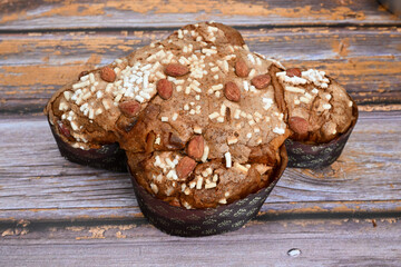 Colomba pasquale or Easter Dove is a traditional Italian dessert prepared with sourdough, almonds and candied fruit top view on wooden background