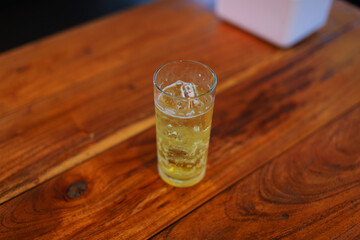 Beer glass with ice placed on a wooden table with copy space