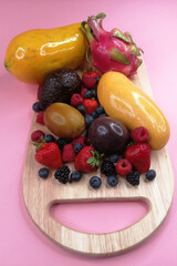 tropical fruits on a pink background