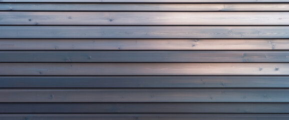 Obraz premium Wooden wall with horizontal planks reflecting soft light at dusk in a modern setting