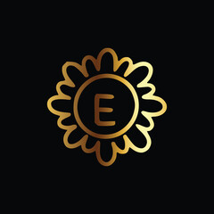 Golden letter E monogram in floral badge style in black background luxury emblem design