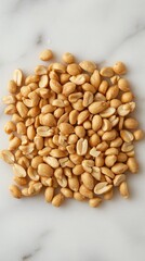 Fototapeta premium Heap of Roasted Peanuts on Marble Surface Capturing Natural Light and Texture for Food Photography Projects