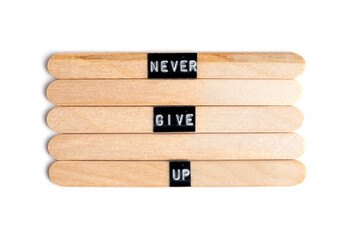 Wooden blocks with words Never give up isolated on white background.