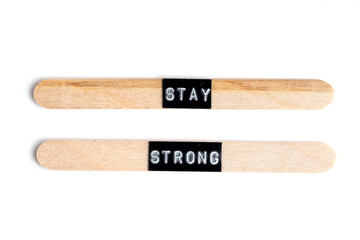 Wooden sticks with word stay strong isolated on white background.
