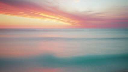 Fototapeta premium Pink and orange sunset reflecting on calm ocean water