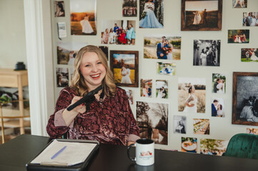 Woman laughing while holding a tablet candid