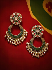 Obraz premium beautiful pair of earrings on red background