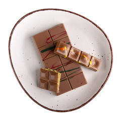 Dubai chocolate bar with filling made of kataifi (knafeh, kadayif) and pistachio  paste. Trendy chocolate on plate isolated on white background. Top view.