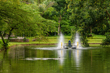 Paddle wheel aerator in the middle of a large pond