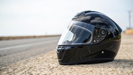 Fototapeta premium Black Motorcycle Helmet on Roadside