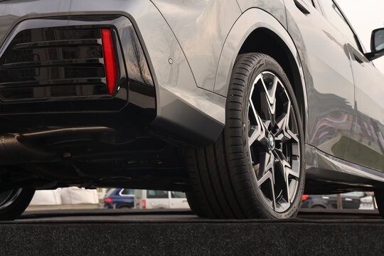 BELGRADE, SERBIA - FEBRUARY 22, 2025: Part of BMW brand car. Wheels and tires Continental wheel tyre tire of luxury vehicle sporty car with a powerful braking system and discs. automobile perspective