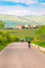 Group of Cyclists Enjoying a Ride Through Rural Green Countryside in Springtime
