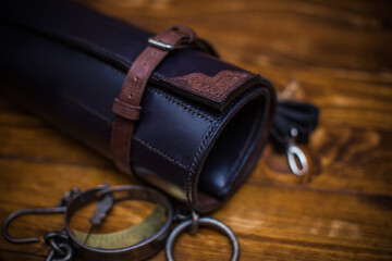 Elegant Leather Tool Roll With Buckle Fastening on Wooden Background for Craft Storage