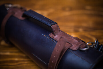 Close-Up of a Leather Strapped Roll On a Wooden Surface with Detailed Texture
