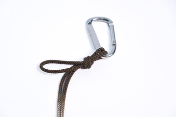 Metal carabiner with rope tied on a white background.