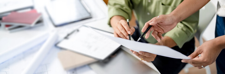 Architects interior designer hands working with Blueprints and documents for a home renovation for...