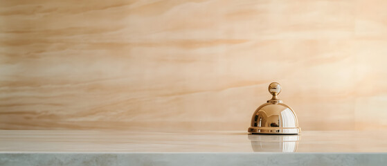 luxury hotel bell resting on polished marble counter, reflecting warm tones from elegant background. This captures sense of sophistication and hospitality
