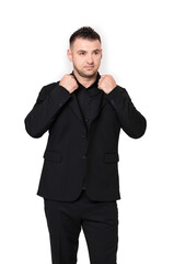 A handsome dark-haired man wearing a business suit, a black shirt on a white background