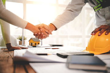 engineering team shaking hands start planning for architecture Engineer sketching construction project concept with architect equipment Consult about their construction project.