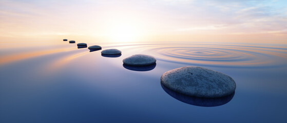 Row of dark stones in calm ocean with evening sun with horizon - tranquil scenery © peterschreiber.media