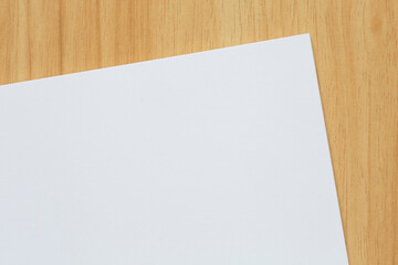 blank white sheet of paper on wooden table