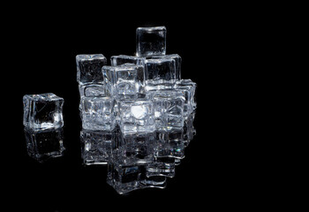 blocks of natural ice cubes loosely arranged on a black background