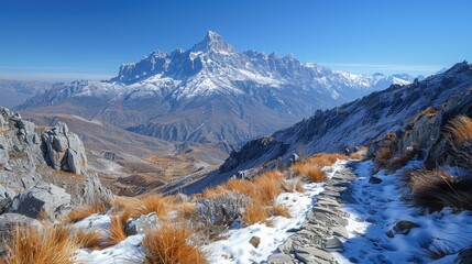 Snowy mountain trail overlooking valley in autumn