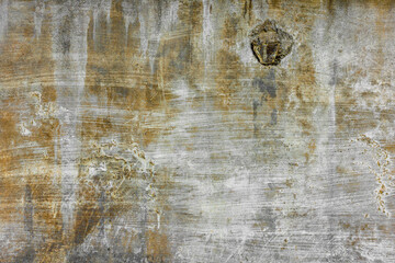 rough concrete wall with old white paint strokes yellow streaks and stains