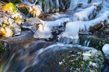 Thawed streams of a frozen waterfall close-up